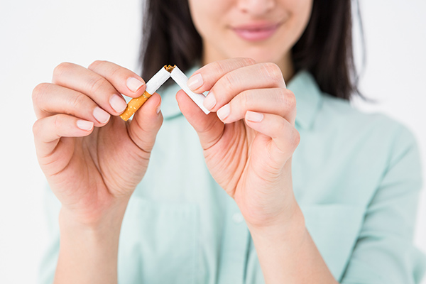 Woman snapping a cigarette